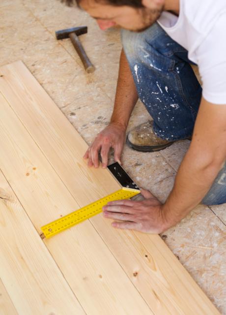 man installing wooden flooring